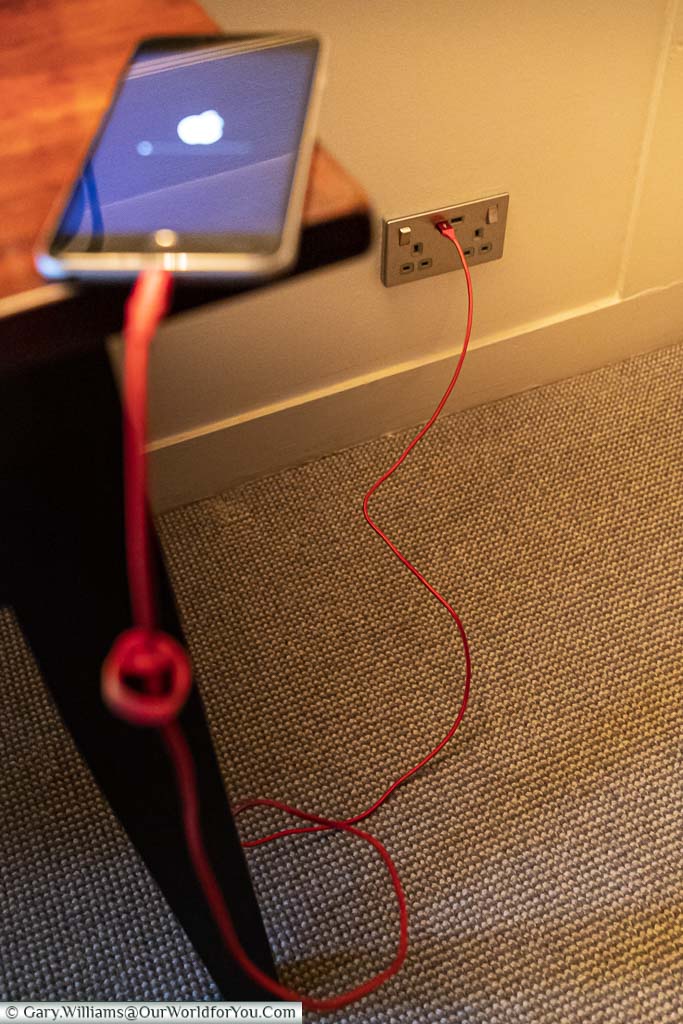 An iPhone charging directly off the USB socket included in the mains power socket.
