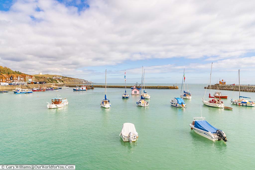 A view of with boats in Folkestone Harbour with a pink version of Holiday Home – By Richard Woods in the centre.