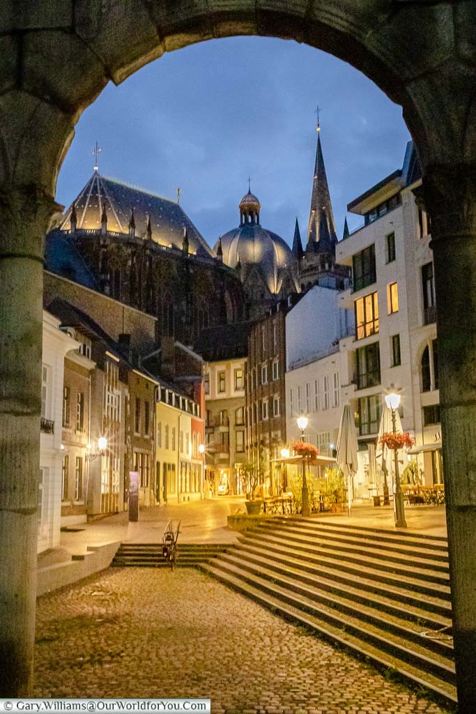 The Dom through the Roman arch at dusk. Here you can find Café Zum Mohren, one of the many places to find regional cuisine.