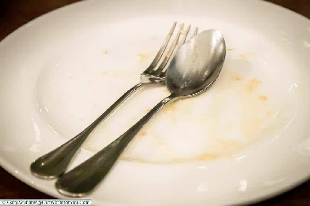An empty plate after Gary had finished his dessert.