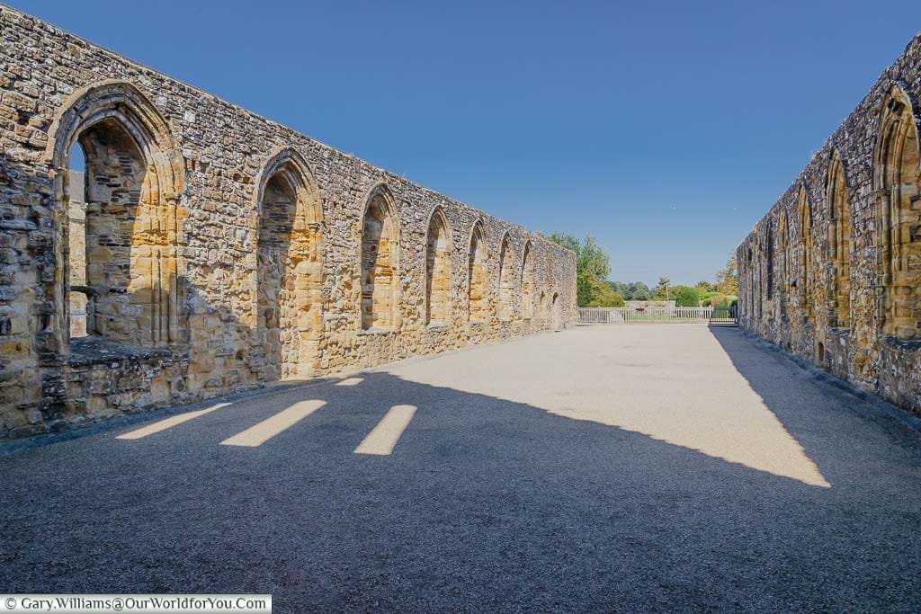 Standing inside the remains of the Abbey dormitory looking up at a deep blue sky.