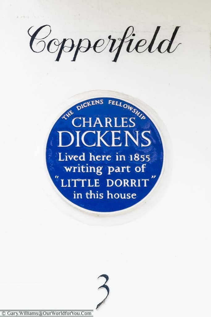 A blue plaque issued by the Dickens Fellowship on a residence in Folkestone. The plaque reads "Charles Dickens lived here in 1855 writing part of Little Dorrit in this house".