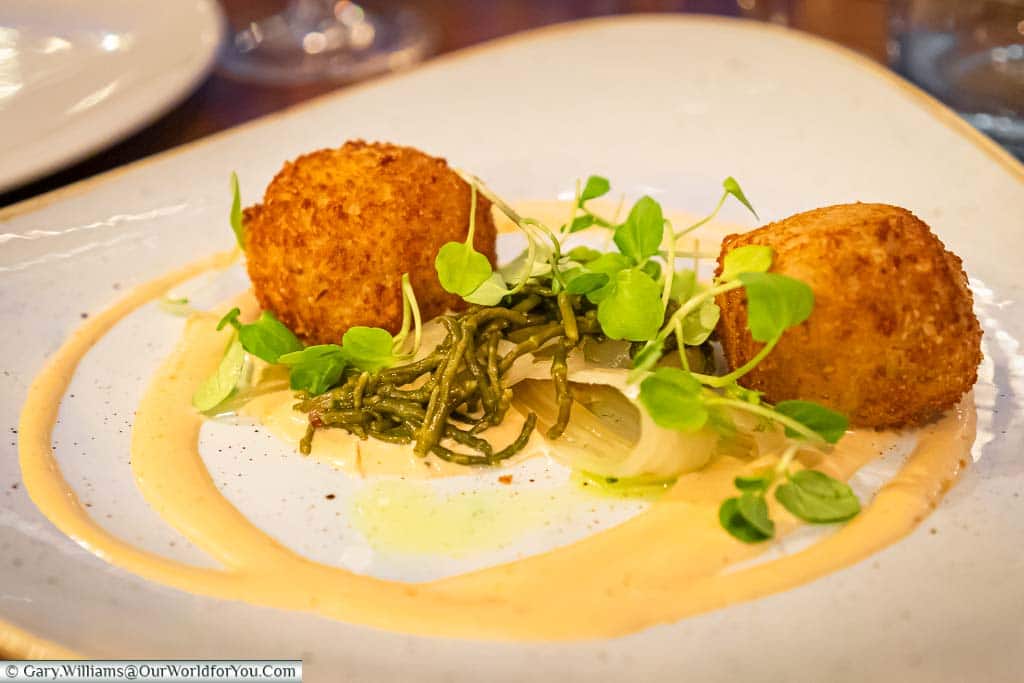 Gary's starter of Bon bon crab. Two deep-fried breaded balls of crab meat set on brown crab mayonnaise and samphire salad.