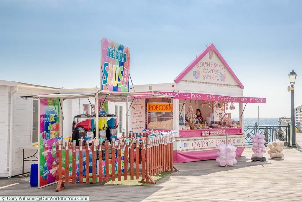 Traditional stall on Hastings Pier selling candyfloss, slush puppies, popcorn & sticks of rock