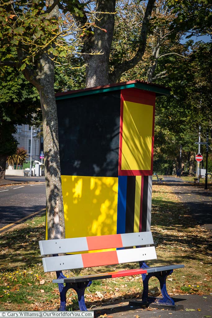 A brightly coloured park bench and street vendor's hut as part of the Dusiadu installation by Atta Kwami in the Folkestone Triennial 2021
