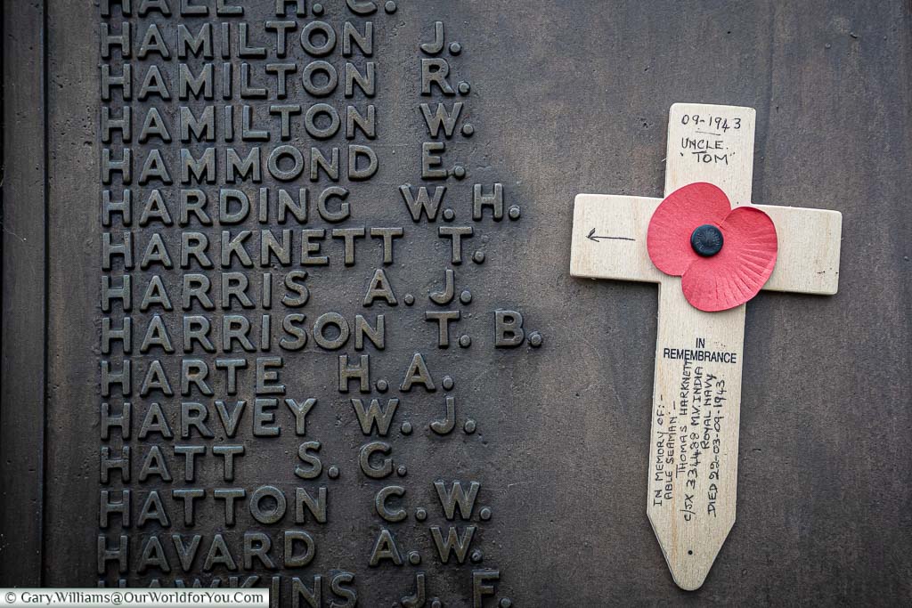 Attached to the brass plaque next to the inscription for Harknett T.A is a small wooden cross decorated with a Poppy, dedicated to Uncle Tom