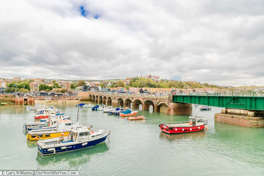 Boats in the harbour in front of the Harbour viaduct, and the green swing bridge leading to the old Folkestone Harbour Station.