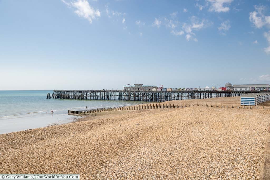 The view of Hastings pier from the promenade across the pebble beach