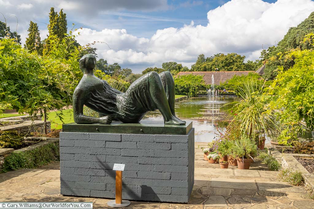 Henry Moore's statue 'Draped Reclining Figure' in front of the Jellicoe canal and the water lily pavilion.