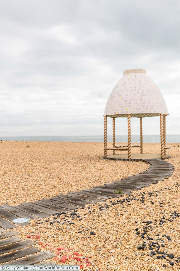 Jelly Mould Pavilion – By Lubaina Himid. A small seating pavilion on Folkestone's beach topped with an egg-shaped roof said to resemble a victorian jelly mould.