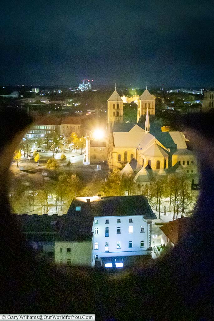 Looking through the Neogothic spire of St. Lamberti church down to St Paulus Dom at night.
