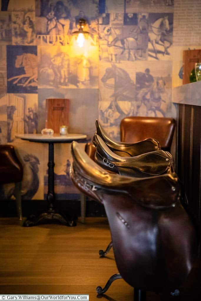 Saddles provide the seating at the 'Pickwick Papers' themed Dozen Bar of the White Horse Hotel in Dorking