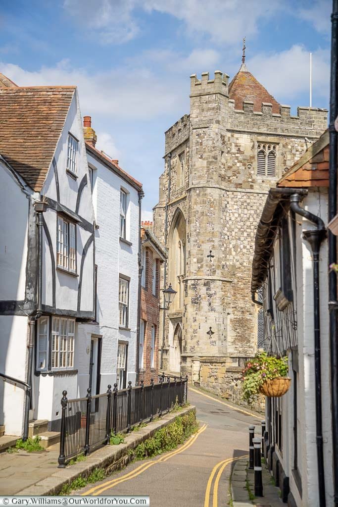 A view of the tower of St Clements Church from Hill Street, lined on either side by half-timbered houses