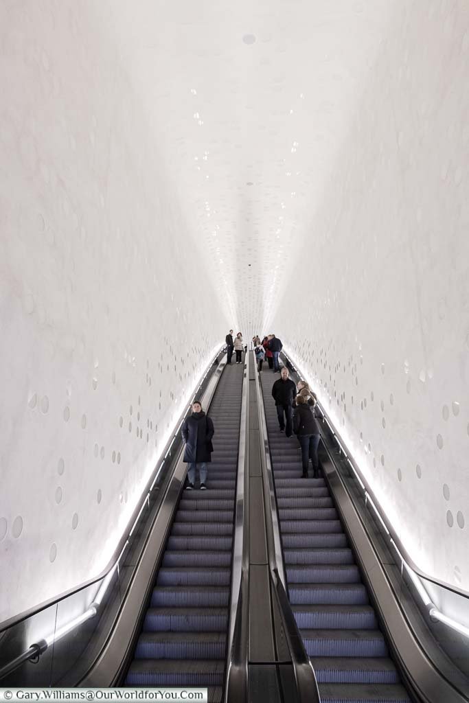 Looking up for the dramatic white tiled escalator to the first stage of the Elbphilharmonie building.