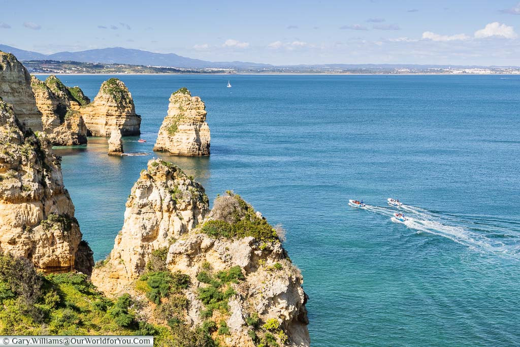 Powerboats off the coast of Ponta da Piedade, just outside Lagos on Portugal's Algarve coast.