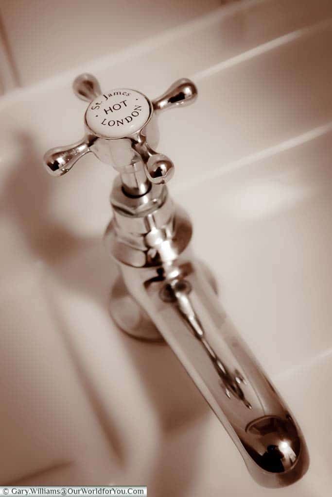 A traditional chrome hot water tap from our bathroom in the White Horse hotel in Dorking