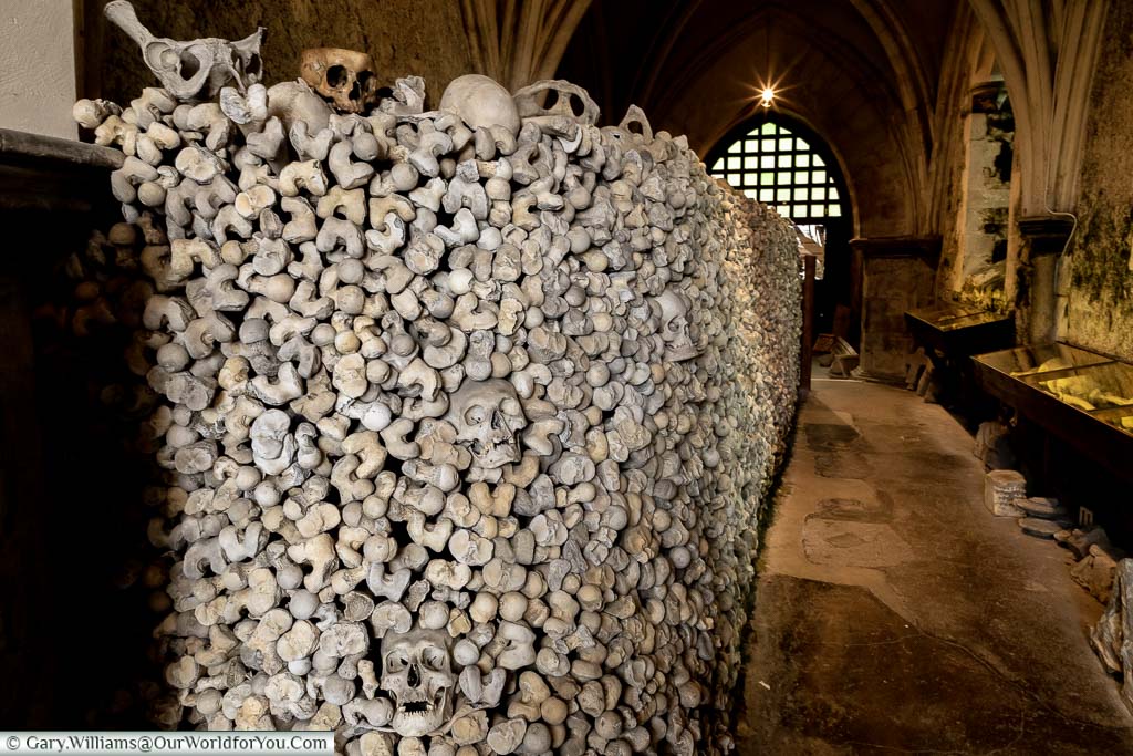 A wall made of stacked bones inside the ossuary of St. Leonard’s Church and Crypt in Hythe