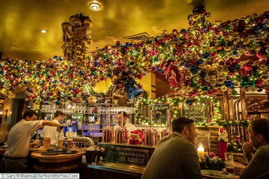 The brightly decorated bar of the Brauhaus Joh. Albrecht. There's hundreds of coloured baubles.