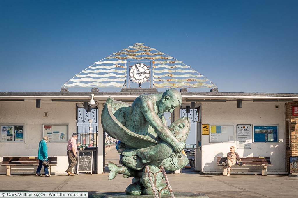 The 3 meter high, bronze statue, 'Embracing the Sea' of a man in a boat wrestling a fish, in front of Deal Pier