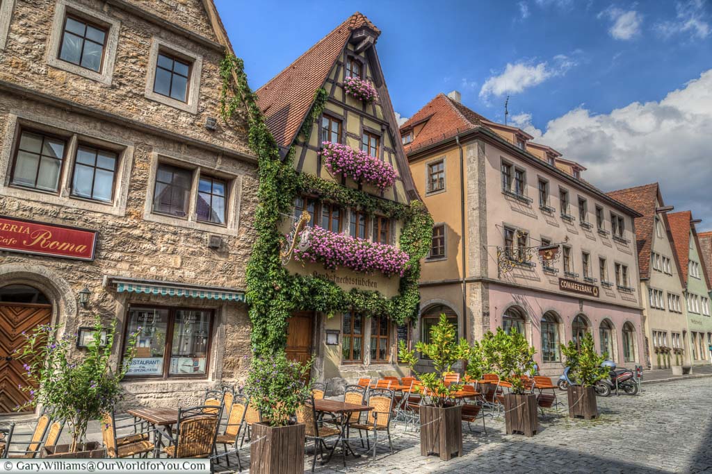 Traditional Barbarian half-timbered buildings decorated with flowering hanging baskets and Ivy growing over the buildings.