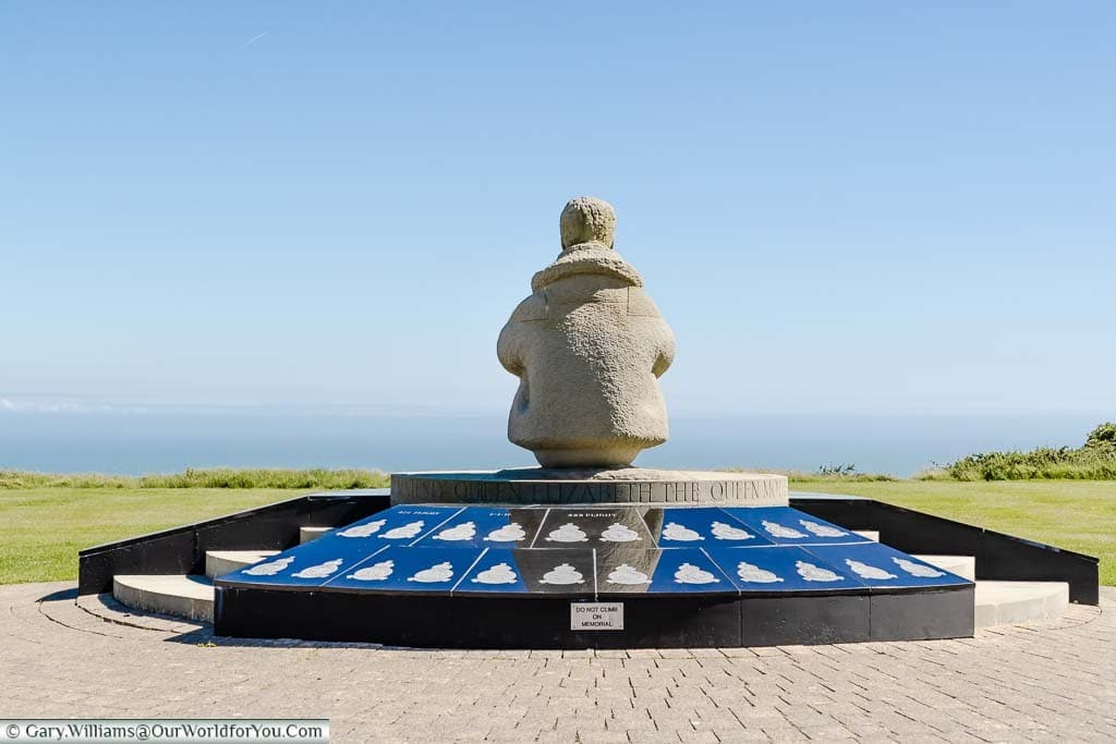 The rear view of the centrepiece statue of a seated airman overlooking the English Chanel at the Battle of Britain Memorial