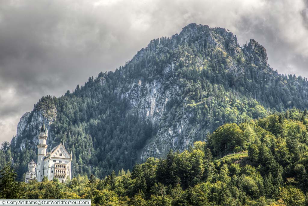 The magnificent Schloss Neuschwanstein set in deep Bavaria, dwarfed by the mountains behind it.