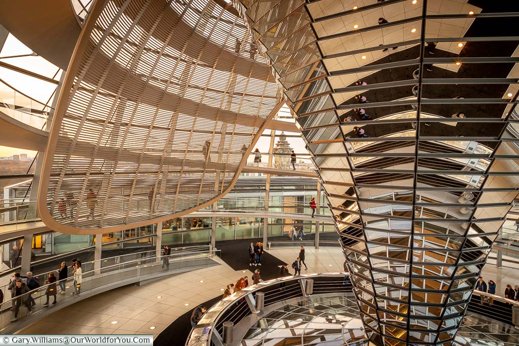 A view of the giant reflector within the dome of the Reichstag. You can also see the screen the shields direct sunlight and rotates to follow the path of the sun.