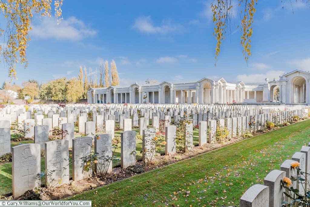 The view across the headstones to the Memorial Wall at the Arras Military Cemetery, France