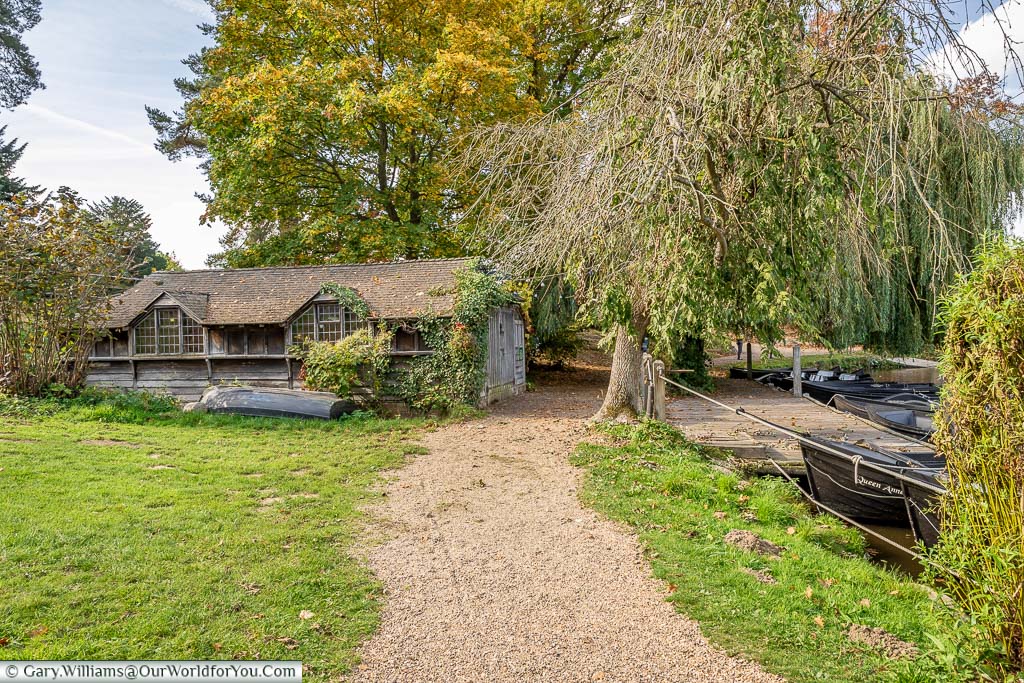 A gravel path leading to the boathouse on the shores of the lake at Hever Castle in Kent