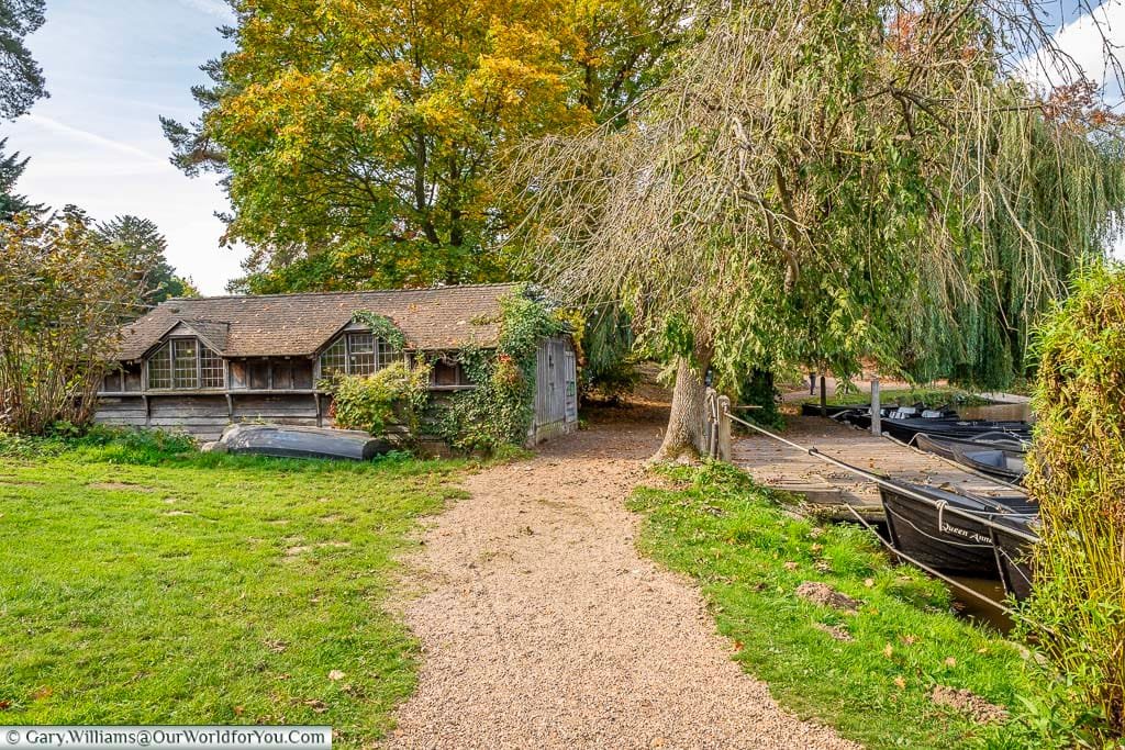 A gravel path leading to the boathouse on the shores of the lake at Hever Castle in Kent