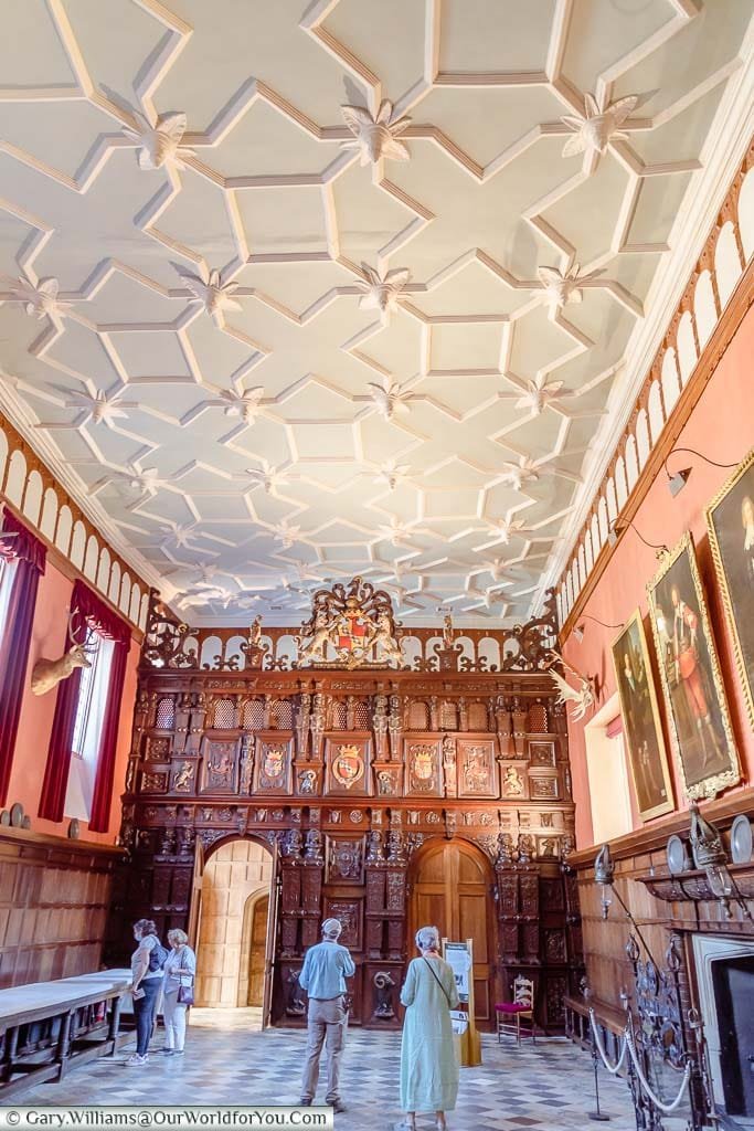 The immense ornamented oak screen at the end of the Great Hall at Knole House