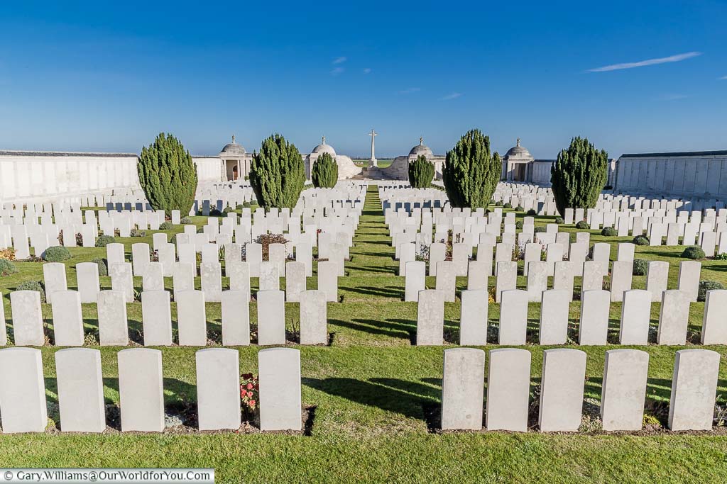 The view from the entrance of Loos Memorial in France, over the rows and rows of headstones, to the Cross of Cacrifice in the distance.