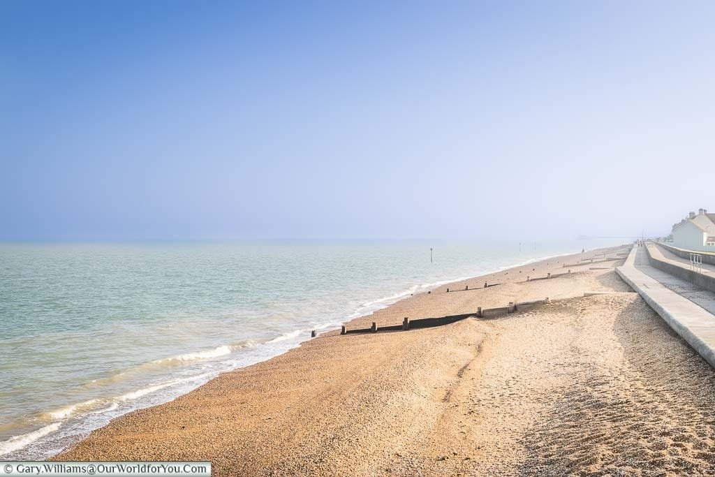 The golden shale beach of Deal, under a deep blue sky, stretching along the Kent Coastline