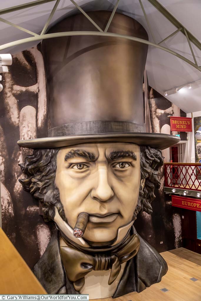 A huge bust of Isambard Kingdom Brunel smoking his familiar cigar, waering his top hat in the Being Brunel exhibition at the SS Great Britain
