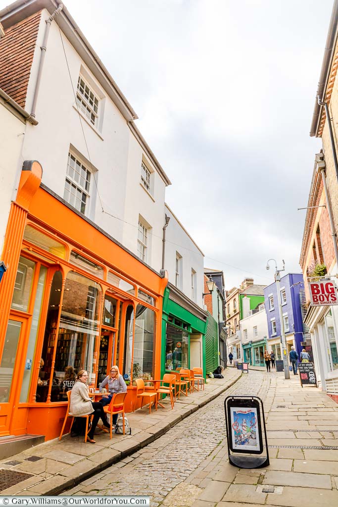 Looking up Folkestone’s old High Street with a narrow cobbled lane in the centre and brightly coloured artisan shops either side that now occupies the creative quarter of the town.