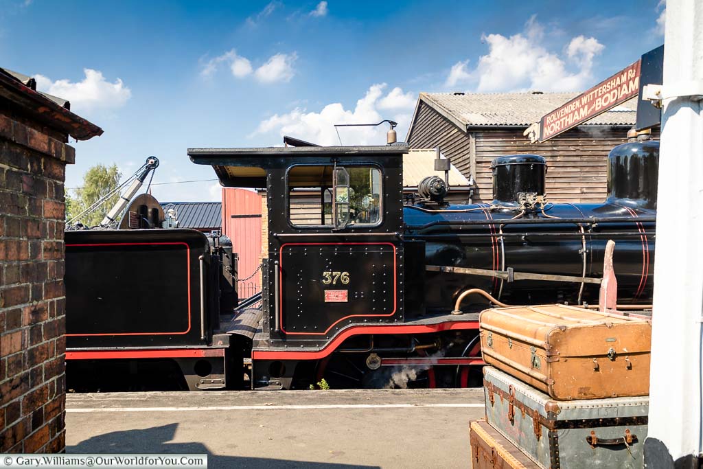The black steam locomotive the Norwegian at Tenterden Station next to the sign to Rolvenden, Wittersham Road, Northiam & Bodiam