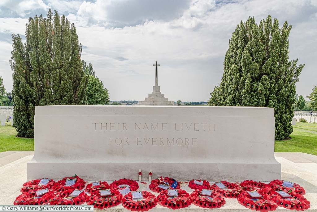 A mass of poppy wreathA mass of poppy wreaths in front of the Stone of Remembrance at Tyne Cott Military Cemetery in Belgiums in front of the Stone fo Remembrance at Tyne Cott Military Cemetery in Belgium