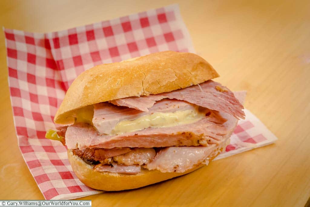Thick slices of freshly cooked ham, served with German mustard, in a bread roll from the Cologne Christmas Markets