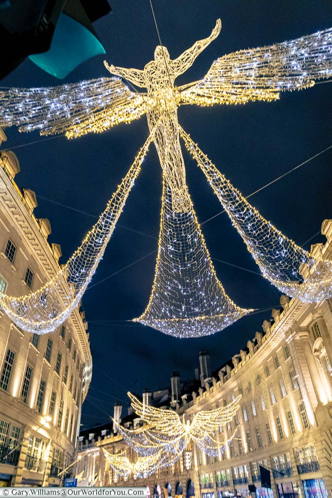 Looking up to the the illuminated golden angels that decorate Regent Street at Christmas.