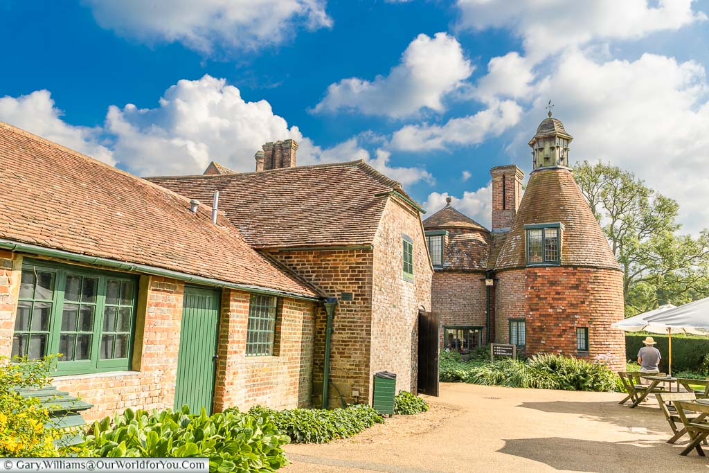 A courtyard in front of the oast house, topped with a dovecote, at Bateman’s, East Sussex