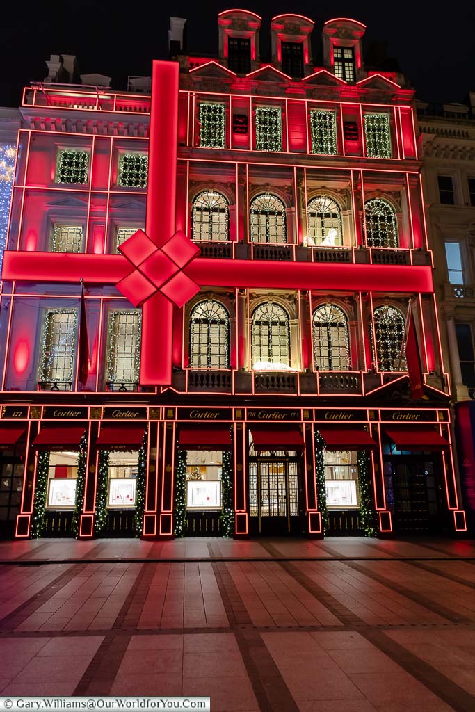 The Cartier store in London’s New Bond Street, decorated as a giant Christmas present, tied up with an illuminated red bow.