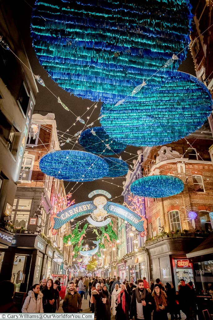 The illuminations above Carnaby Street with a One Ocean, One Planet theme as Christmas shoppers go about their festive fun.