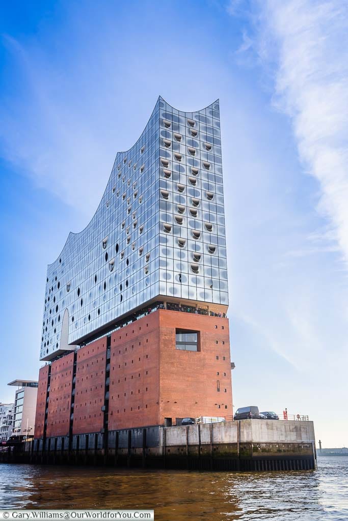 The Elbphilharmonie on an island in Hamburg's Harbour with its red brick base and the unique glass upper levels of this impressive concert hall.