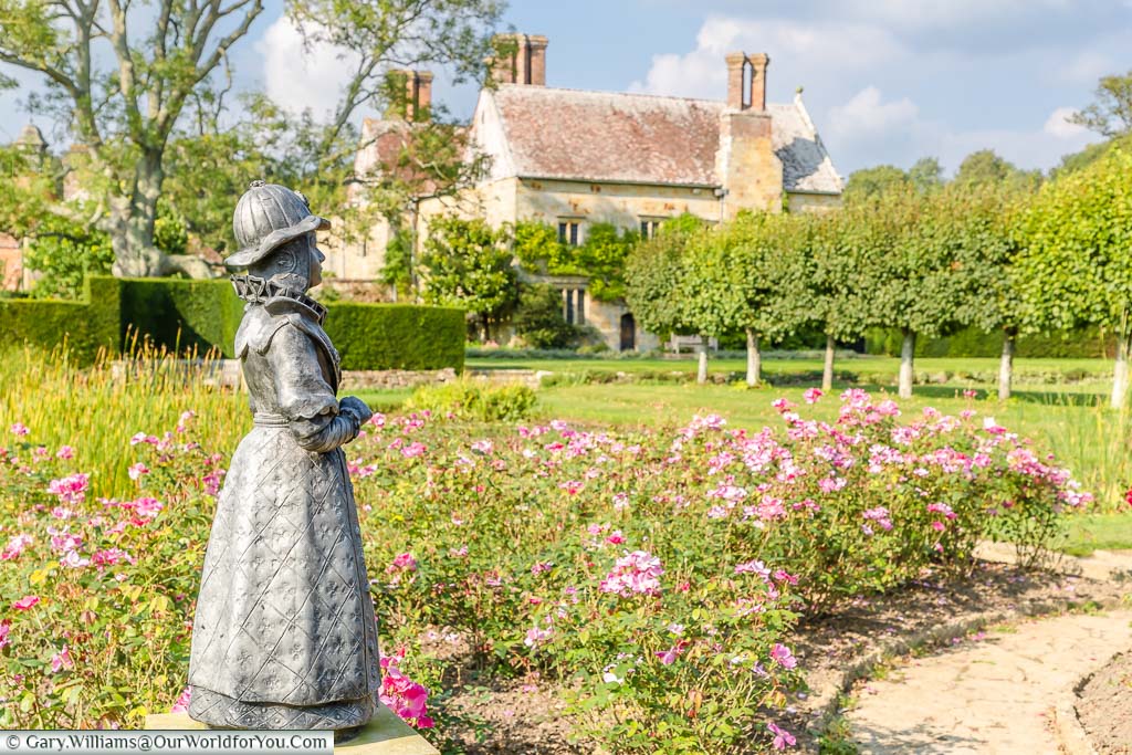 A small statue of an Elizabeth female figure in the gardens of Rudyard Kipling's country house, Bateman's in East Sussex.
