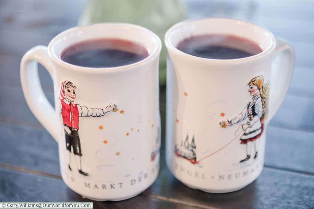 Two decorative mugs of glühwein from Cologne's Angel Christmas Market.