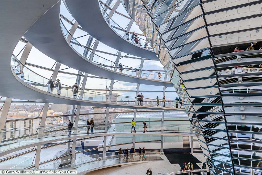 Inside the dome of the Reichstag. A spiral staircase take you to the top, and other back down. The central inverted reflector transfers daylight down to the debating chamber below.