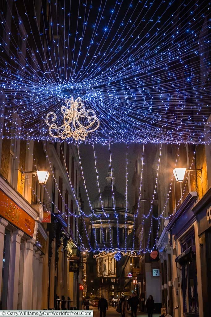 A view along Bow Lane to St Paul's Cathedral under a blanket of Christmas Lights