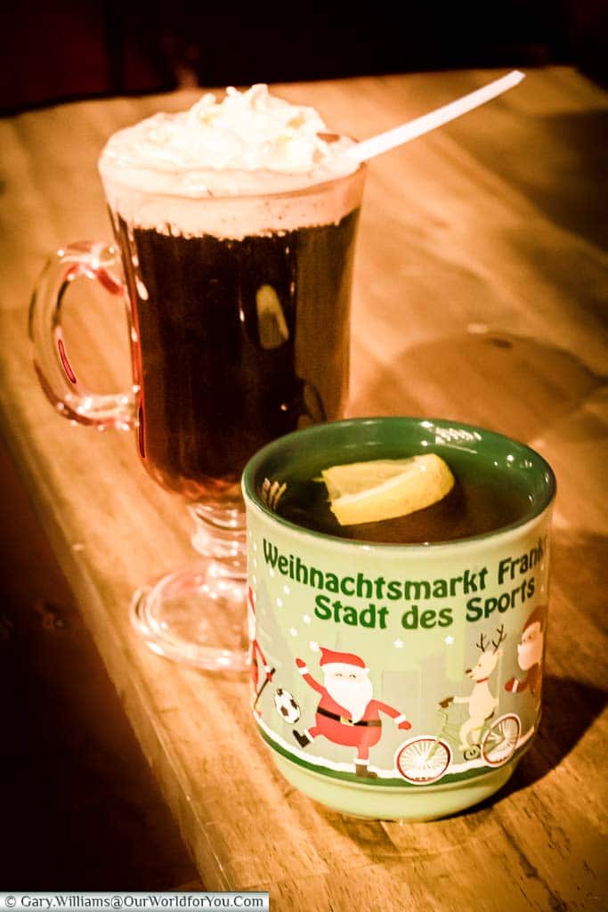 Two drinks from the Frankfurt's Christmas markets. The first is a mug of Frankfurt's speciality apple gluhwein; the other is a glass Irish-Coffee style glass with a cherry gluhwein, topped with cream.