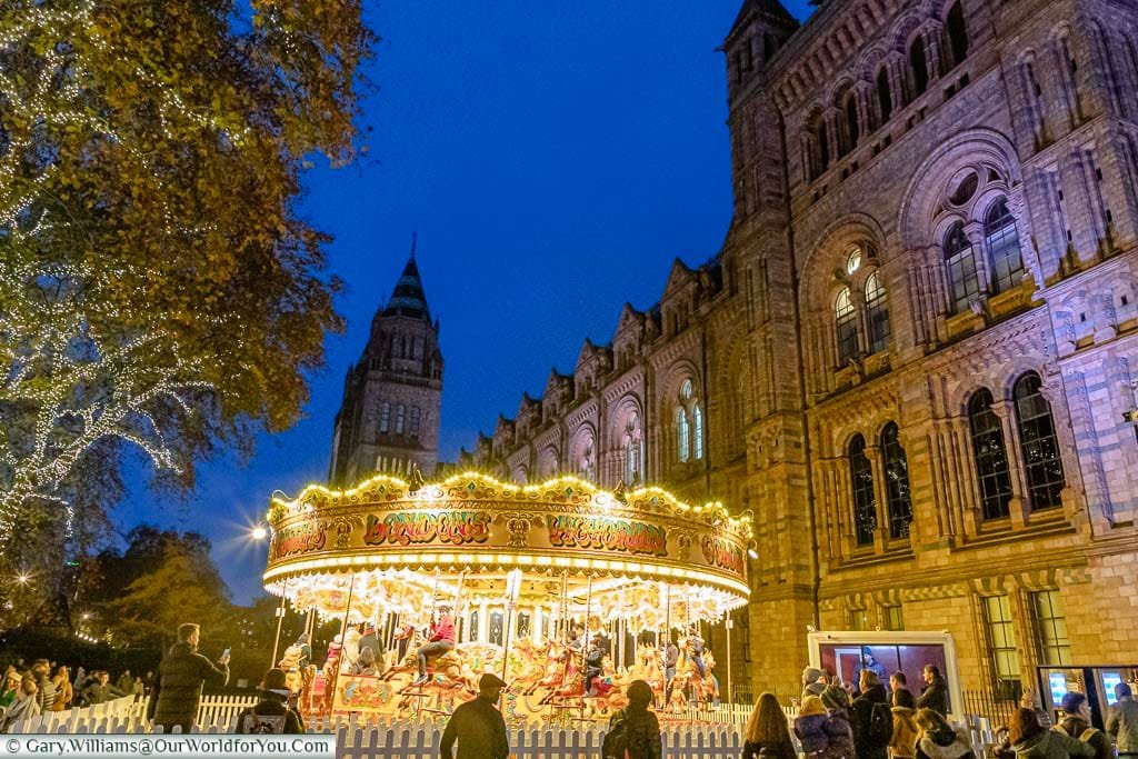 A traditional carousel in front of the Natural History Museum In London’s South Kensington.