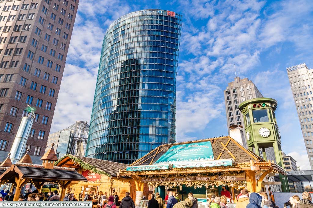Christmas Market huts in Potsdamer Platz, Berlin, surrounded by modern skyscrappers.